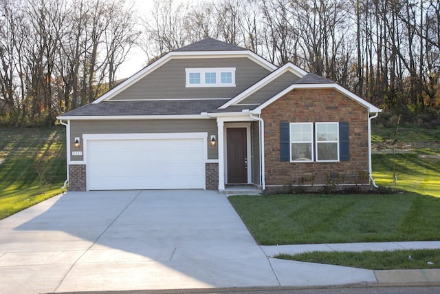 craftsman house featuring a garage and a front yard