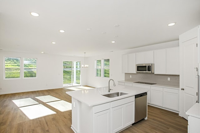 kitchen with stainless steel appliances, sink, a center island with sink, and white cabinets