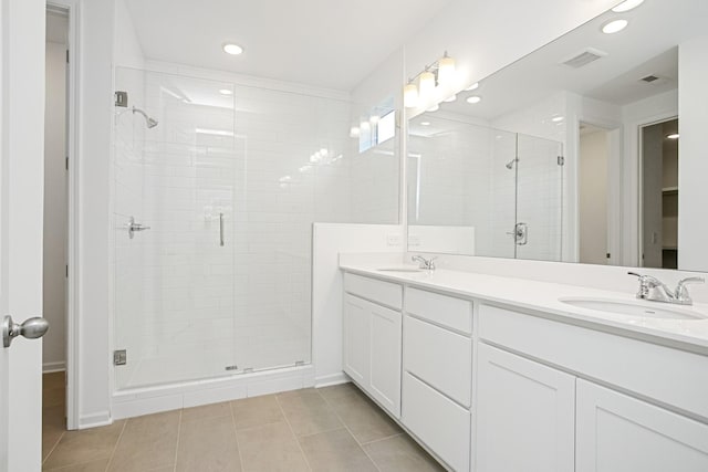 bathroom with tile patterned flooring, vanity, and a shower with shower door