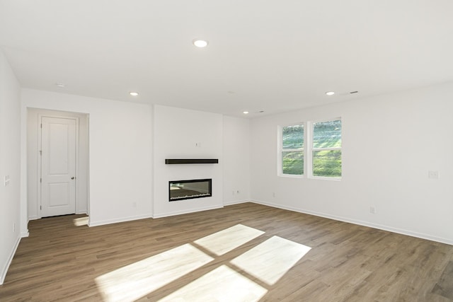 unfurnished living room featuring wood-type flooring