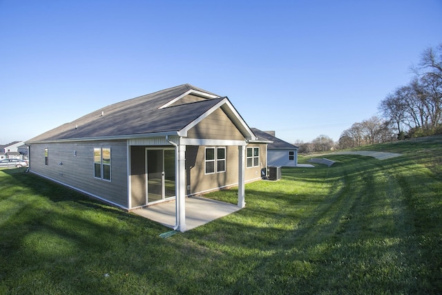 back of property with a yard, a patio area, and central air condition unit