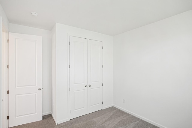 unfurnished bedroom with carpet flooring and a closet