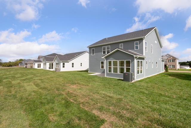 back of house featuring cooling unit and a yard