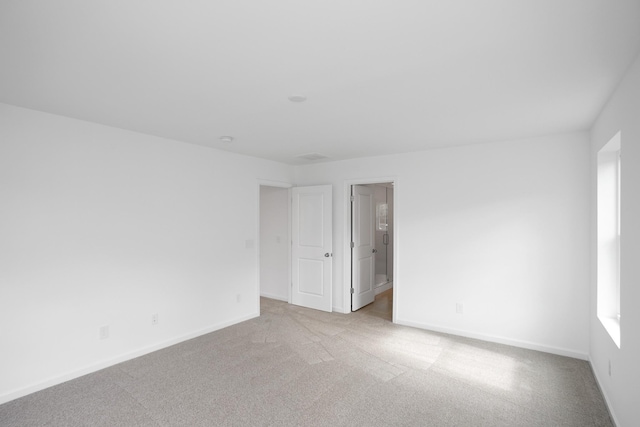 spare room featuring light colored carpet