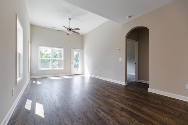 empty room featuring dark wood-type flooring and ceiling fan