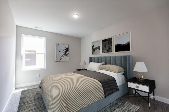 bedroom featuring dark colored carpet