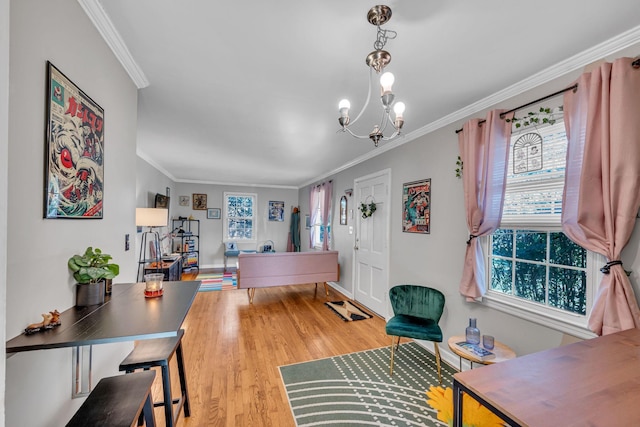 interior space featuring ornamental molding, a notable chandelier, and light wood-type flooring