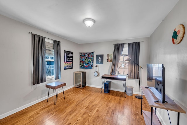 home office with light hardwood / wood-style flooring