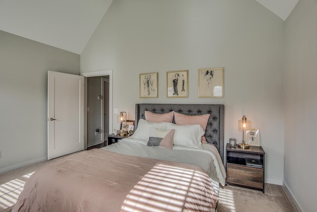 carpeted bedroom with high vaulted ceiling