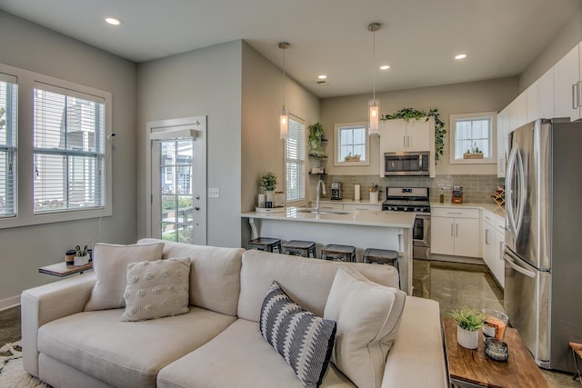 living room featuring sink and a wealth of natural light