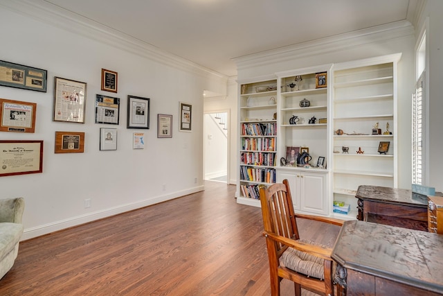 living area with crown molding and hardwood / wood-style floors