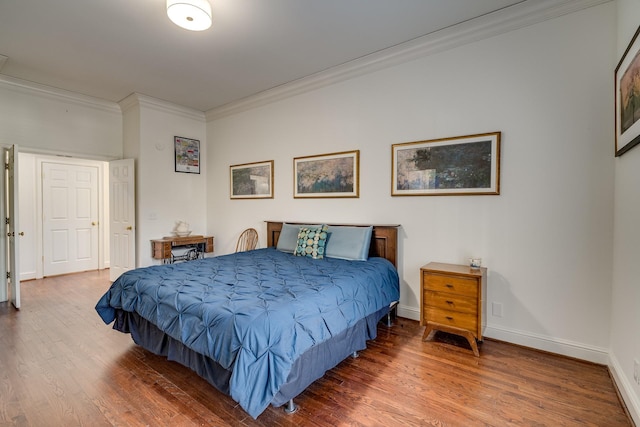 bedroom featuring ornamental molding and hardwood / wood-style floors