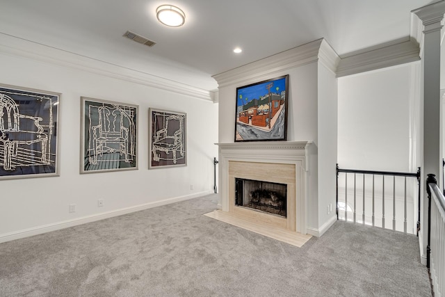 unfurnished living room with ornamental molding and carpet