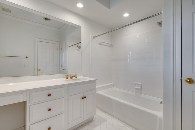 bathroom with tile patterned flooring, vanity, and tiled shower / bath