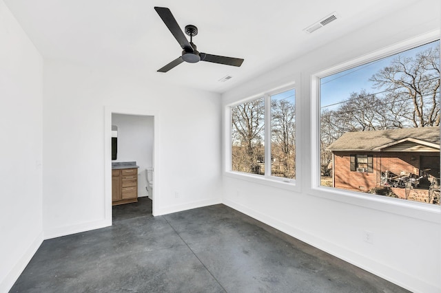 unfurnished sunroom with ceiling fan