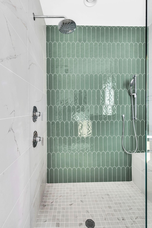 bathroom with a tile shower