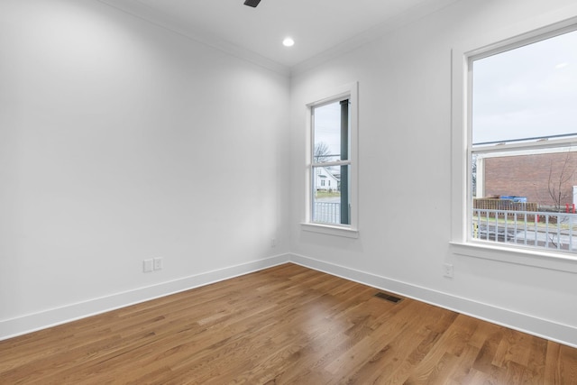 spare room featuring hardwood / wood-style floors, ornamental molding, and ceiling fan