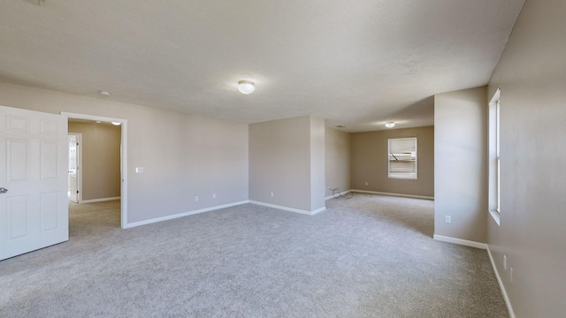 unfurnished room with light carpet