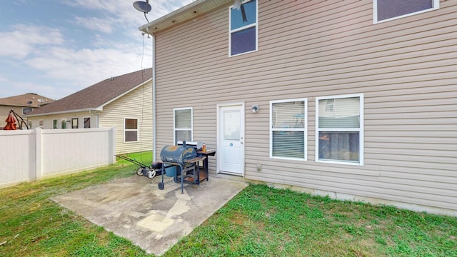 back of property featuring a patio area and a lawn