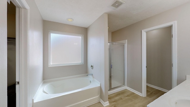 bathroom featuring vanity, hardwood / wood-style flooring, and separate shower and tub