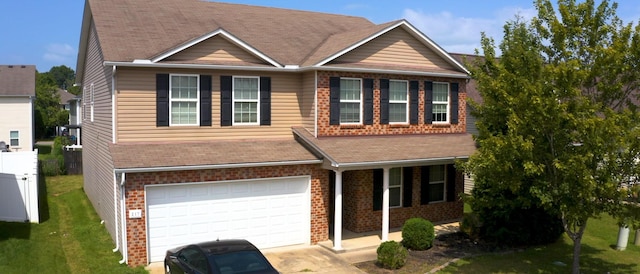 view of front of property with a garage and a front lawn