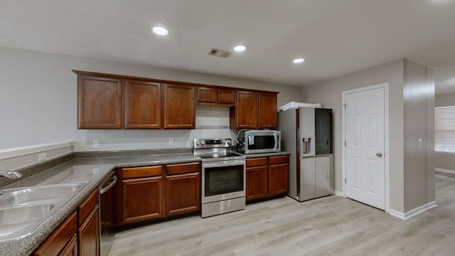 kitchen featuring sink, light hardwood / wood-style flooring, and stainless steel appliances