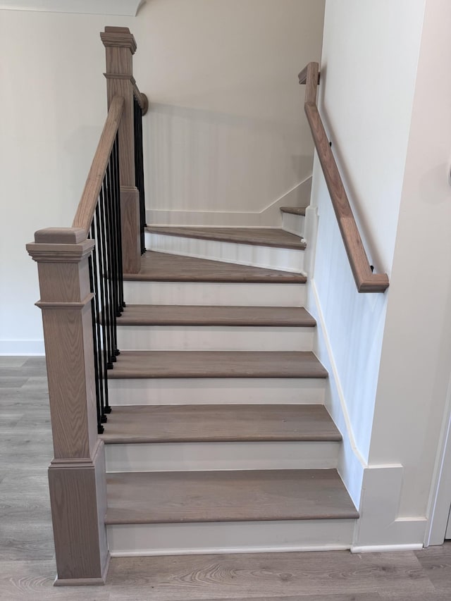 stairway with hardwood / wood-style flooring