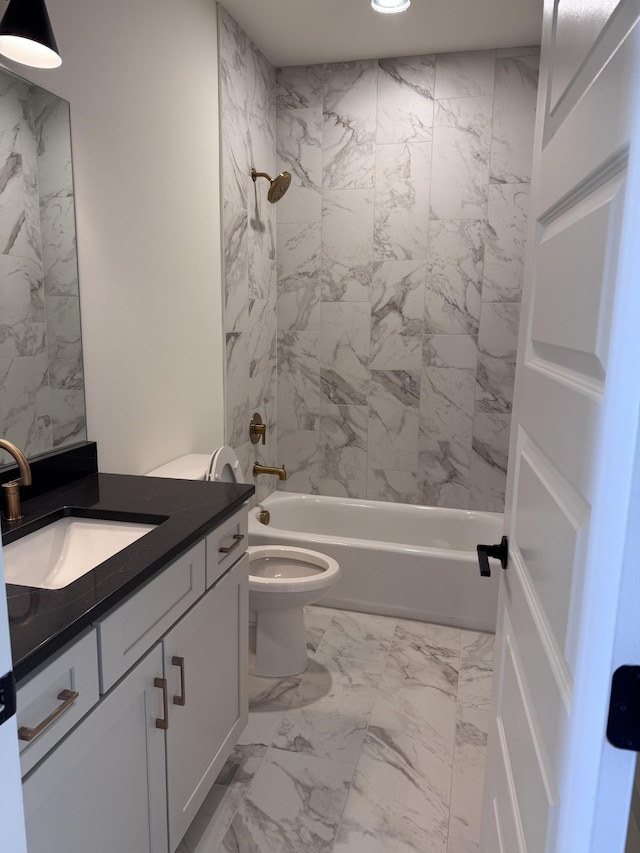 full bathroom with tiled shower / bath, vanity, and toilet