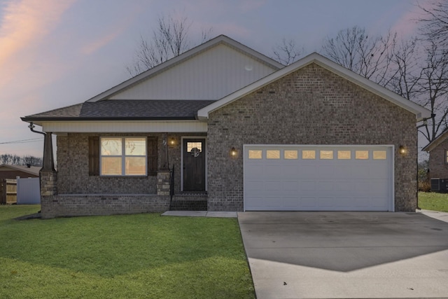 view of front of home featuring a garage and a yard