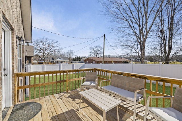 wooden terrace featuring a yard