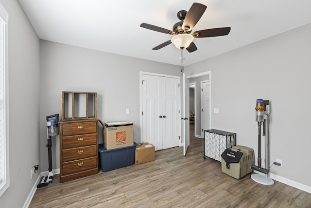 misc room with ceiling fan and light hardwood / wood-style floors