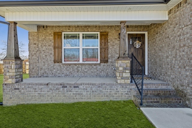 view of exterior entry with covered porch