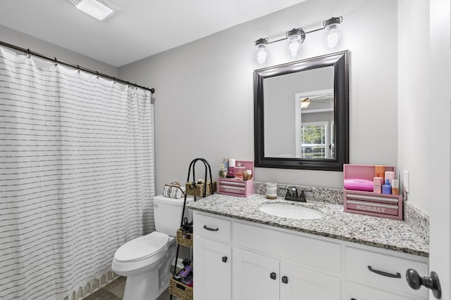 bathroom with vanity, curtained shower, and toilet