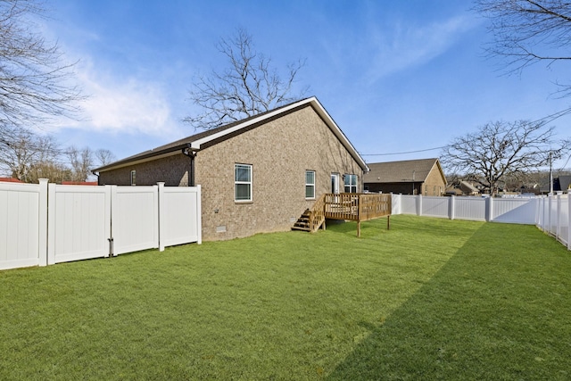 back of property with a lawn and a deck