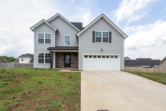 front of property featuring a garage and a front lawn