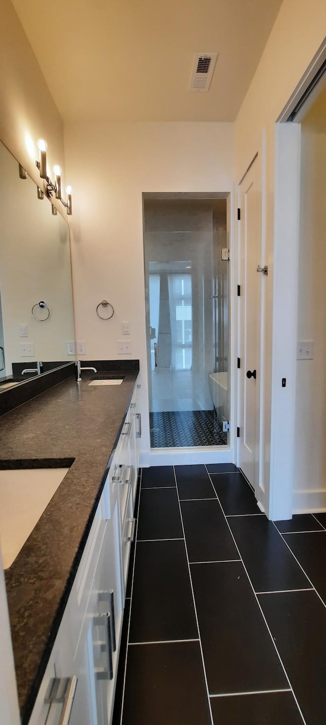 bathroom with vanity, tile patterned floors, and walk in shower