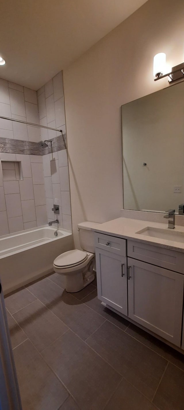 full bathroom with vanity, toilet, tile patterned floors, and tiled shower / bath