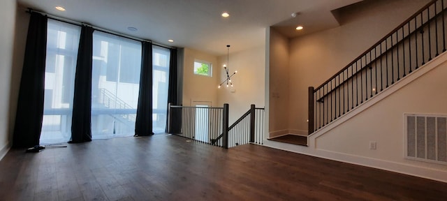 entrance foyer with dark hardwood / wood-style flooring and a wall of windows