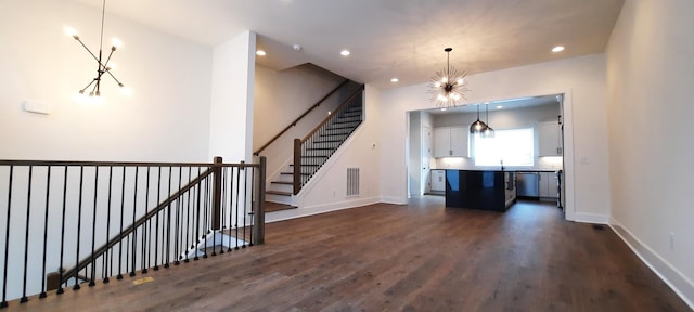 interior space featuring dark wood-type flooring and a chandelier