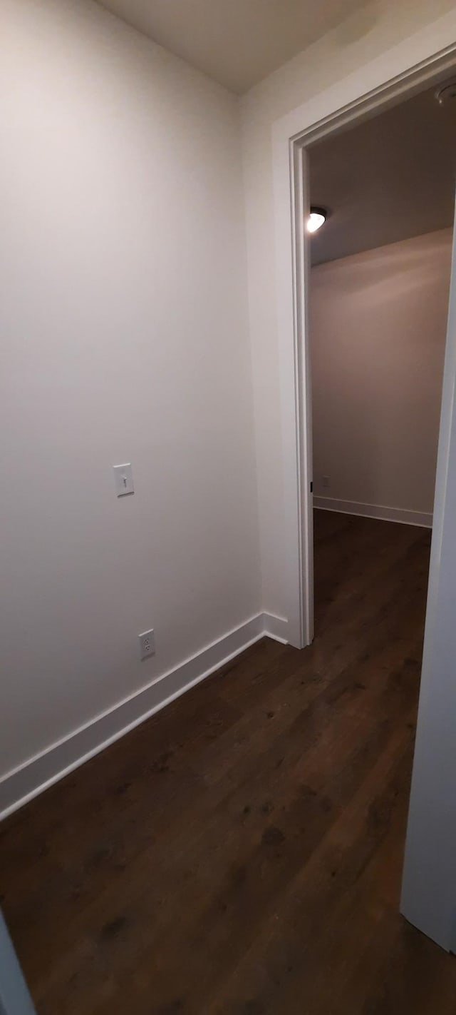 corridor with dark hardwood / wood-style floors