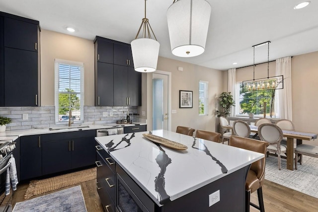 kitchen featuring pendant lighting, a breakfast bar area, dark hardwood / wood-style floors, a kitchen island, and decorative backsplash