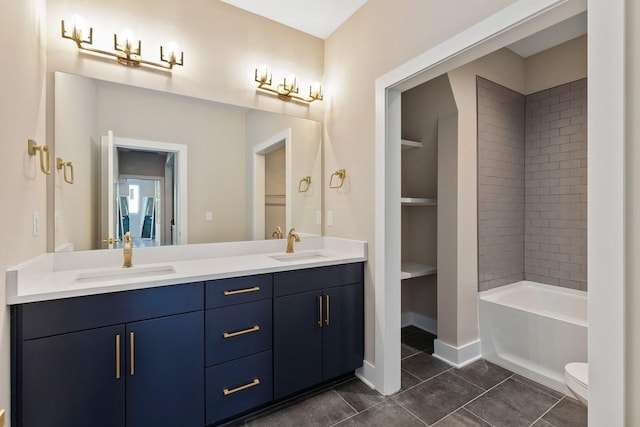 bathroom featuring toilet, vanity, a bath, and tile patterned flooring