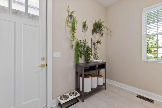 doorway with light tile patterned flooring