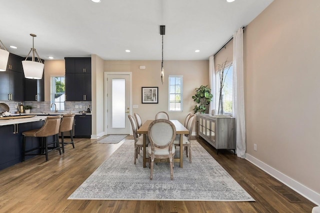 dining space featuring a healthy amount of sunlight, dark hardwood / wood-style floors, and sink