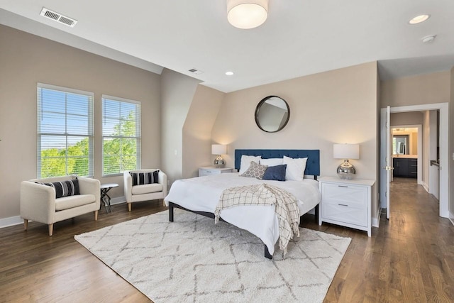 bedroom with dark hardwood / wood-style flooring