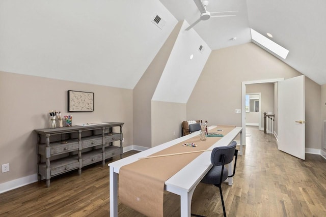 interior space featuring ceiling fan, lofted ceiling with skylight, and hardwood / wood-style floors