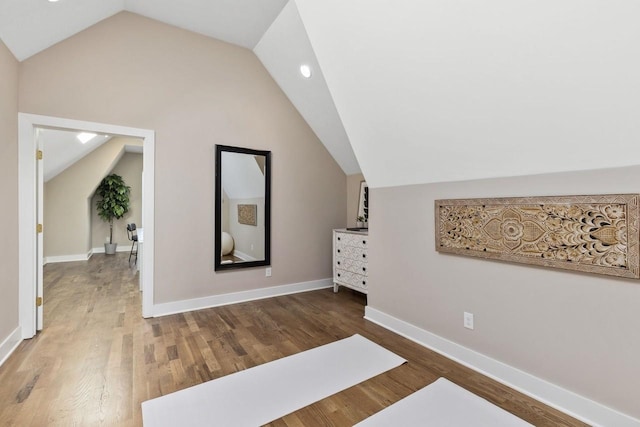 additional living space with lofted ceiling and dark hardwood / wood-style floors