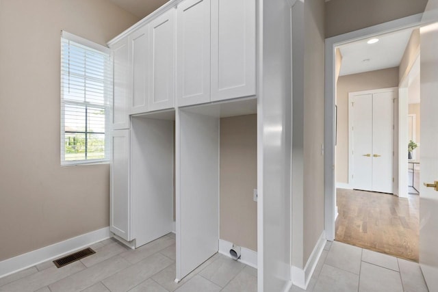 laundry room with light tile patterned floors