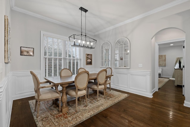 dining area with ornamental molding and dark hardwood / wood-style floors