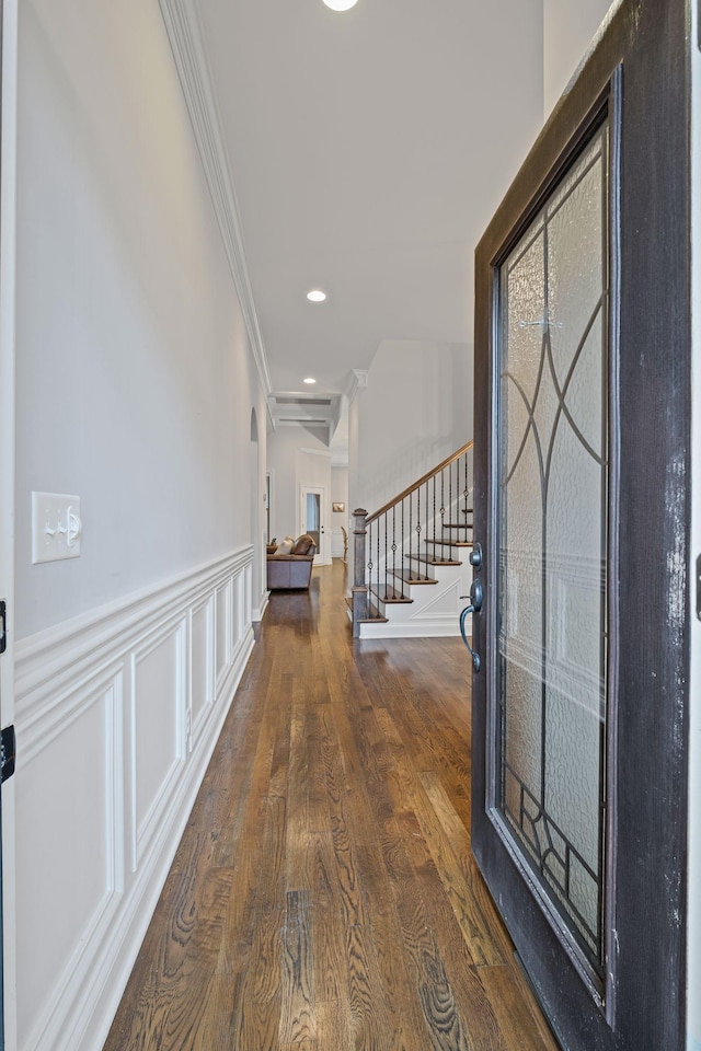 entrance foyer featuring ornamental molding and dark hardwood / wood-style flooring